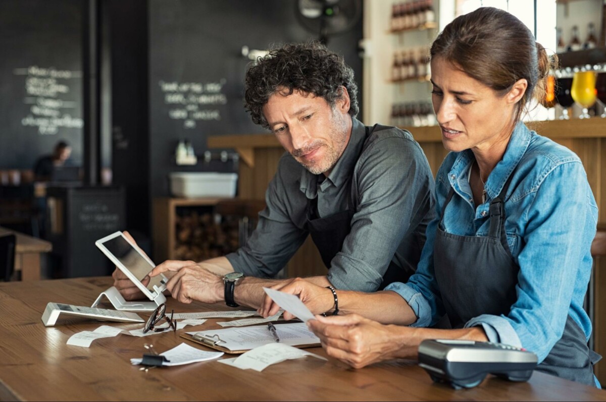 Small business owners calculating finances.